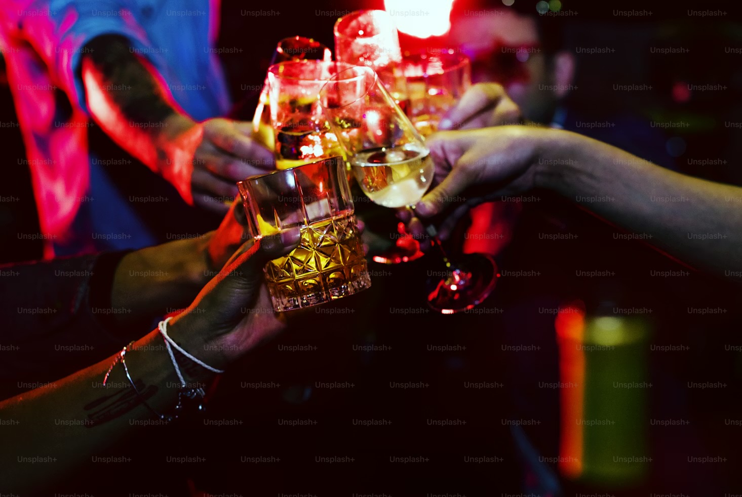 Friends raising glasses in a celebratory cheers at a Melbourne bar