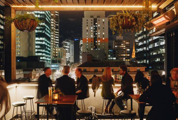 Rooftop bar at night overlooking Melbourne city lights